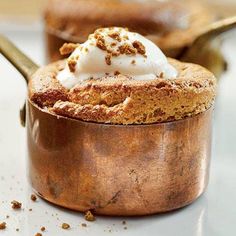 a dessert in a wooden bowl with whipped cream on top