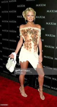 a woman posing on the red carpet with her handbag at an event in miami, florida