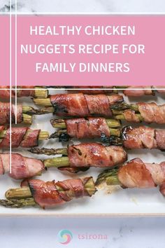 bacon wrapped asparagus on a plate with text overlay that reads healthy chicken nuggets recipe for family dinners