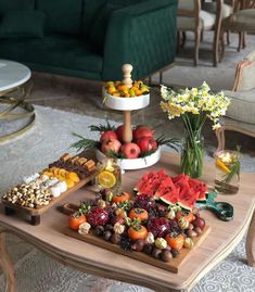 a table topped with lots of different types of fruit and snacks on top of it