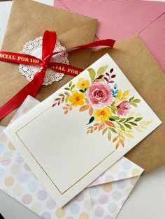 some cards and envelopes on a table