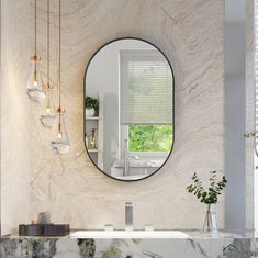 a bathroom with marble counter tops and a round mirror on the wall, along with hanging lights