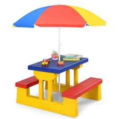 a toy table and bench with an umbrella over it