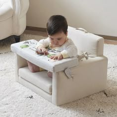 a small child sitting in a white chair