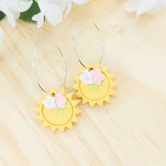 These clay sun earrings are hypoallergenic and lightweight, making them the perfect earrings to wear all day long without feeling any discomfort or pain!  These floral sun earrings are well made earrings that last a really long time with a variety of hardware available.  These gorgeous polymer clay boho earrings are great earrings for work and day to day wear❤️  CARE INSTRUCTIONS:  Moon Clay Shop earrings are handcrafted with polymer clay and must be handled with delicate care. Do not bend the earrings and do not keep them in direct sunlight.  PRODUCT INFORMATION: Color: White, Yellow  Length: 2 inches Width: 1 inch Hardware: Hypoallergenic stainless steel (surgical) Can be personalized (please, message me if you want me to customize these earrings) Available with gold and silver hardware. Convention Gifts, Summer Earring, Boho Earrings, Polymer Clay Earrings, Shop Earrings, Clay Earrings, Polymer Clay, Etsy Earrings, Etsy Accessories