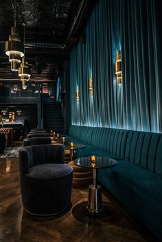 the interior of a restaurant with blue velvet curtains