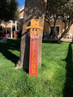 a wooden sign that says welcome to someone in the yard with a cowboy hat on it