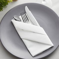 a plate with silverware and napkins on it