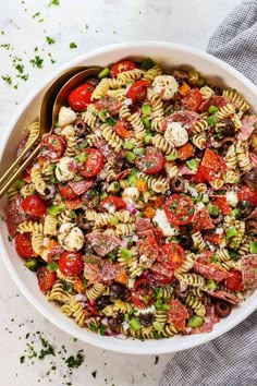 a bowl filled with pasta salad on top of a table