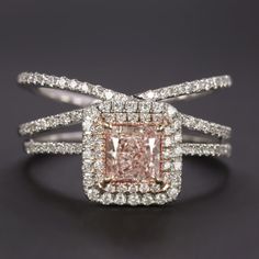 an engagement ring with pink and white diamonds