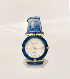 Vintage Christian Dior quartz watch, blue stone round face, Roman numbers, gold tone, water resistant, original blue leather strap signed Dior  Condition: very good vintage, 1980s, fully working, slight wear on strap, barely visible  Measurements: face diameter 3cm Hipster Tops, Roman Numbers, Vintage Designer Bags, Striped Bags, Vintage Christian Dior, Wrist Watches, Round Face, Blue Stone, Vintage Watches