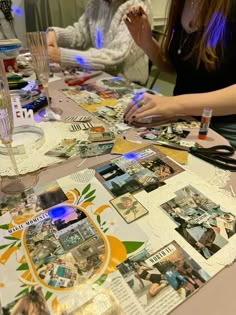 two women sitting at a table with pictures on it