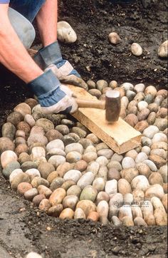 a man is digging into some rocks with a hammer