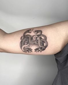 a woman with a snake tattoo on her arm