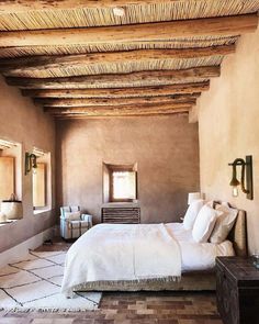 a large bed sitting under a wooden ceiling