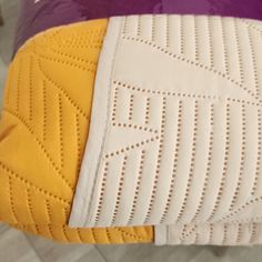 the bottom half of a yellow and white mattress