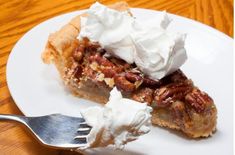 a slice of pecan pie with whipped cream on top