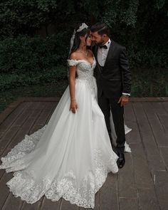 a bride and groom pose for a wedding photo