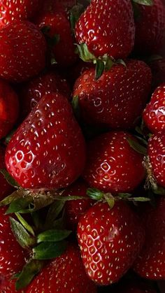 a pile of red strawberries sitting on top of each other