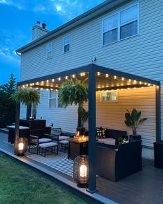 an outdoor patio with lights and furniture