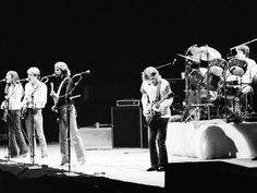 the eagles performing on stage in black and white