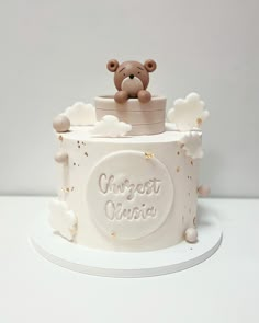 a teddy bear sitting on top of a cake