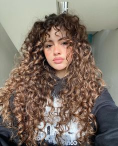 Long Curls With Bangs, Rockstar Curly Hair, Long Layers Wavy Hair Natural Curls, Blonde Curly Hair With Bangs, Caramel Brown Curly Hair, Curly Wispy Bangs, Long Curly Hair With Bangs And Layers, Long Layers Curly Hair, Curly Cut With Bangs