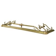 an antique brass shelf with ornate designs on it