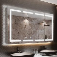 a bathroom with two sinks and a large mirror in it's wall mounted frame