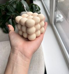 a hand holding a bunch of small white balls