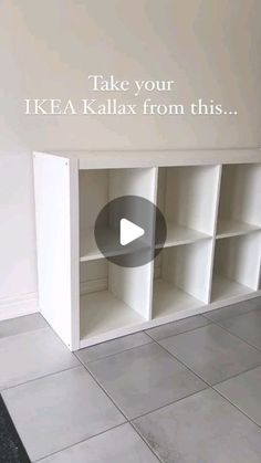 a white bookcase sitting on top of a tiled floor next to a wall with an advertisement