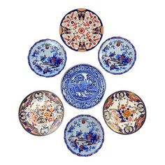 six blue and white plates with designs on them