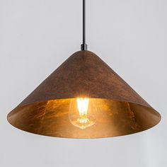 a light hanging from a ceiling fixture with a bulb on it's side and an orange light in the middle