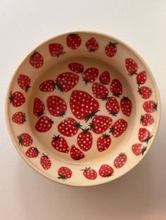 a bowl with strawberries painted on it