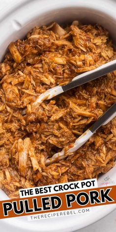 the best crock pot pulled pork recipe in a white casserole dish with tongs