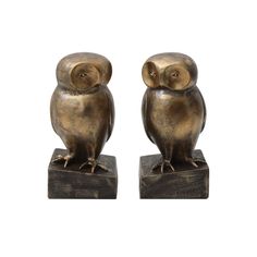 two bronze owl figurines sitting on top of each other