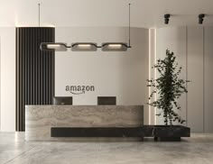 the front desk of an amazon store with a plant in it's centerpiece