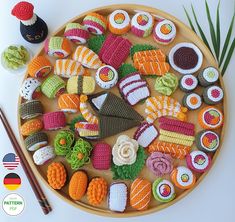 crocheted sushi platter with chopsticks on the side next to it