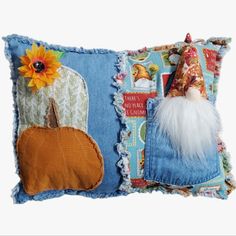 a decorative pillow with a patchwork pumpkin and gnome on it