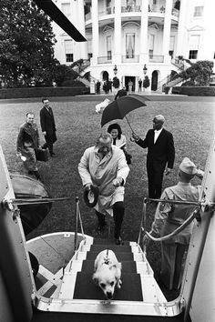 an old black and white photo of people in front of the white house with a dog