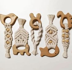 four wooden toys made to look like animals and roped together with beads on them