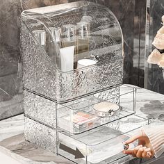 a clear acrylic box sitting on top of a marble counter