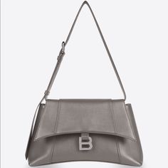 Balenciaga Downtown Small Shoulder Bag, Hourglass Shape, Smooth Semi Shiny, Color: Dark Mink Gray (Kinda On The Brown/Taupe Side In Natural Lighting), 100% Authentic, Never Worn, Comes With Dust Bag. Designer Gray Top Handle Shoulder Bag, Modern Gray Shoulder Bag With Dust Bag, Designer Gray Shoulder Bag, Gray Leather Evening Shoulder Bag, Evening Gray Leather Shoulder Bag, Luxury Gray Shoulder Bag With Silver-tone Hardware, Luxury Gray Shoulder Bag For Office, Designer Gray Bag With Branded Hardware, Gray Rectangular Shoulder Bag With Branded Hardware