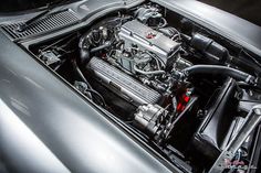 the engine compartment of a silver sports car