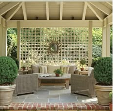 an outdoor living area with couches and chairs