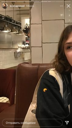 a woman sitting at a table in a restaurant