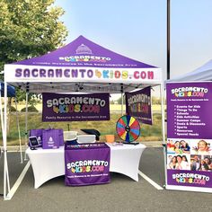 a purple and white tent sitting on top of a parking lot