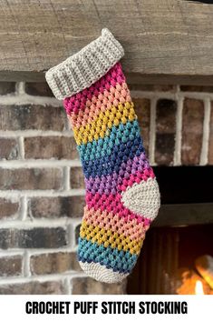 a crochet christmas stocking hanging from a fireplace