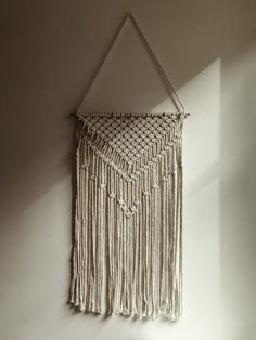 White Macrame wall hanging on white wall. Branch Macrame Wall Hanging, Short Macrame Wall Hanging, Macrame Green Wall Hangings, Black And Cream Macrame Wall Hanging, Grey Macrame Wall Hanging, Bamboo Rods, Natural Boho, Natural Cream, Sea Wall