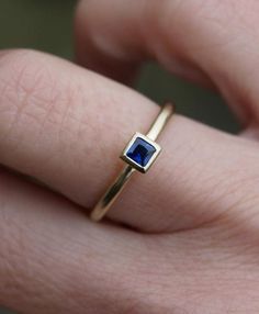 Small 3mm square dark blue sapphire is set in an 18ct gold  ring. This ring can be stacked with others and is also available with an emerald and a ruby or a diamond (extra cost).The band is 1.5mm round, so overall a delicate but solid ring. Made to order in your size. Orders take 3-4 weeks. Sapphires are the birthstone for Septemebr babies.For other stacking rings go to:www.etsy.com/shop/karenjohnsondesignor facebook.com/karenjohnsondesign Rectangular Blue Sapphire Ring In 14k Gold, Sapphire Ring Gold, Gold Topaz Ring, White Topaz Engagement Ring, Garnet Ring Silver, White Gold Diamond Earrings, Gold Sapphire Ring, Saphir Ring, Gold Topaz